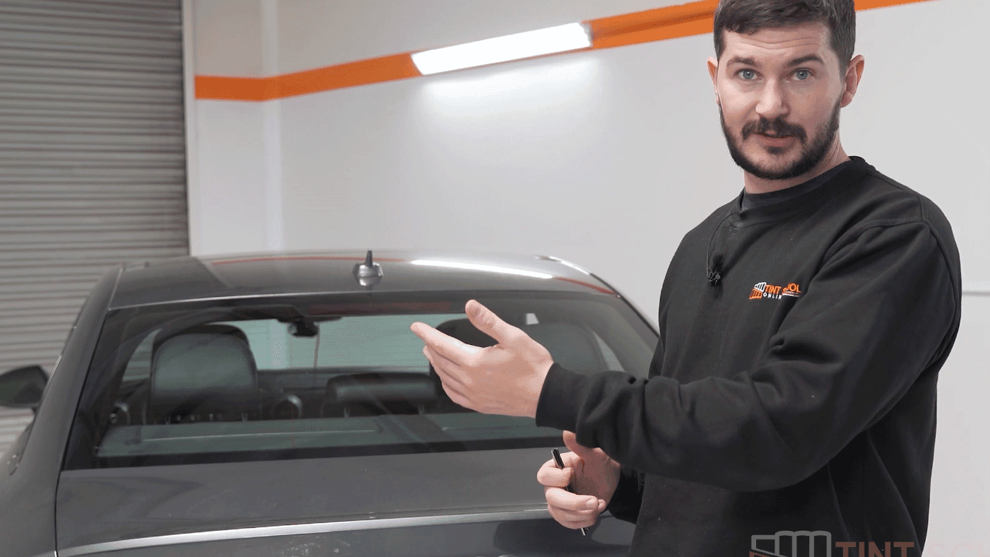 Elliot Baker teaching window tinting in the workshop
